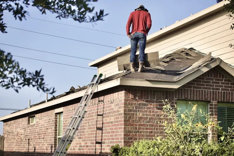 Professional roofer working on a residential roof in Shady Hollow